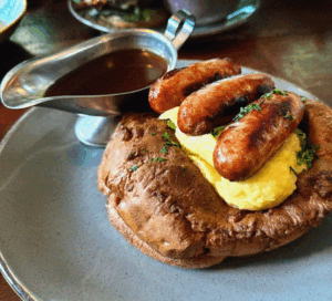 Food offers. A single plate of classic sausage and mash with rich onion gravy, featured as part of a True North January food offer.